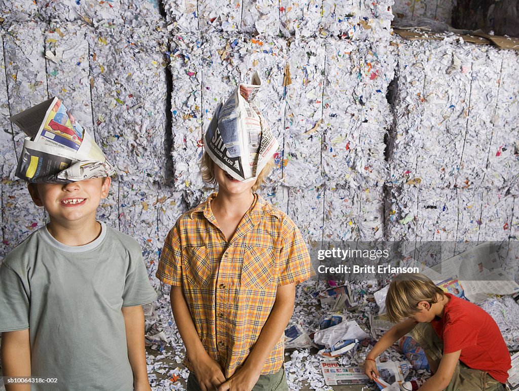 Boy Using Paper Boys Making Paper Aeroplane In Recycling Centre High-Res Stock Photo ...