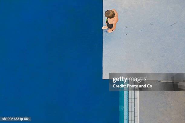 boy (6-7) standing on diving board, overhead view - brave ストックフォトと画像