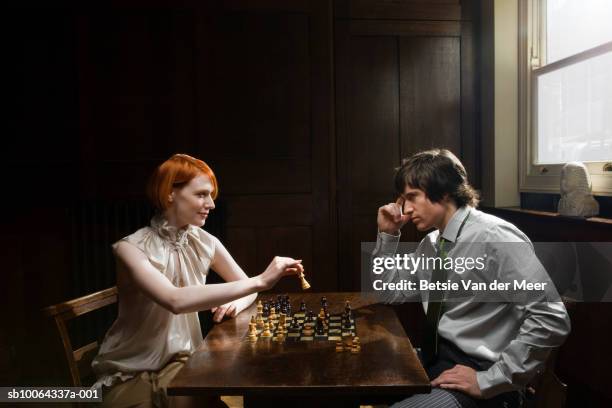 couple playing chess at table, side view - chess bildbanksfoton och bilder