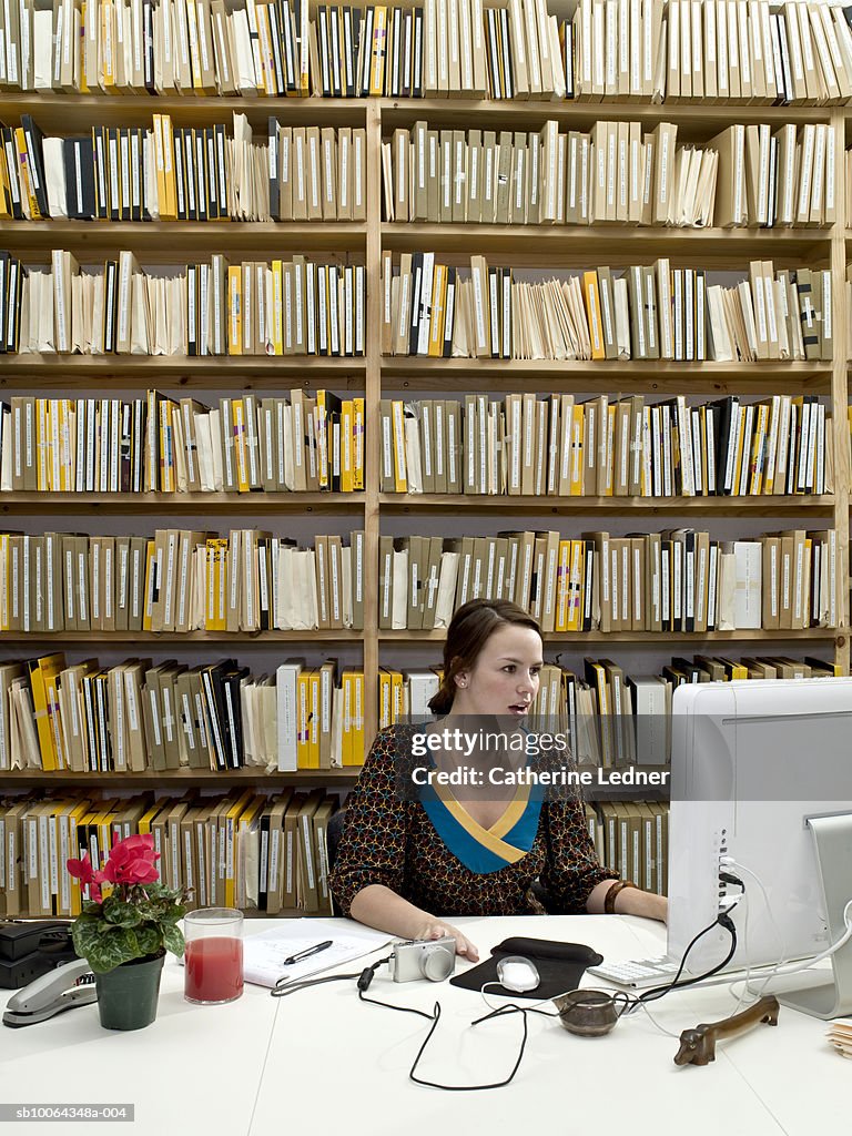 Young woman looking at computer, mouth open