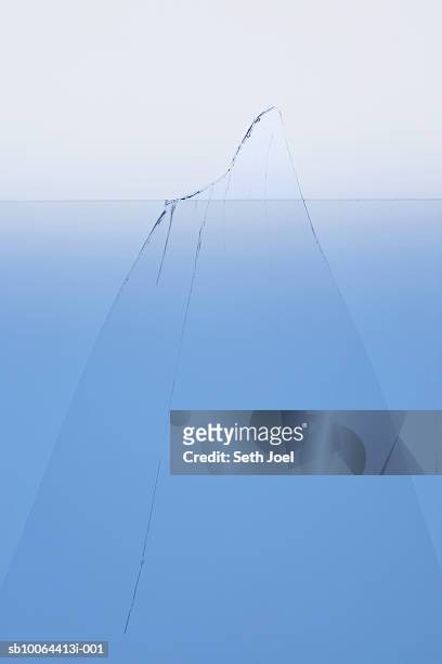 iceberg protruding above water surface, surface view, studio shot - iceberg above and below water stock pictures, royalty-free photos & images