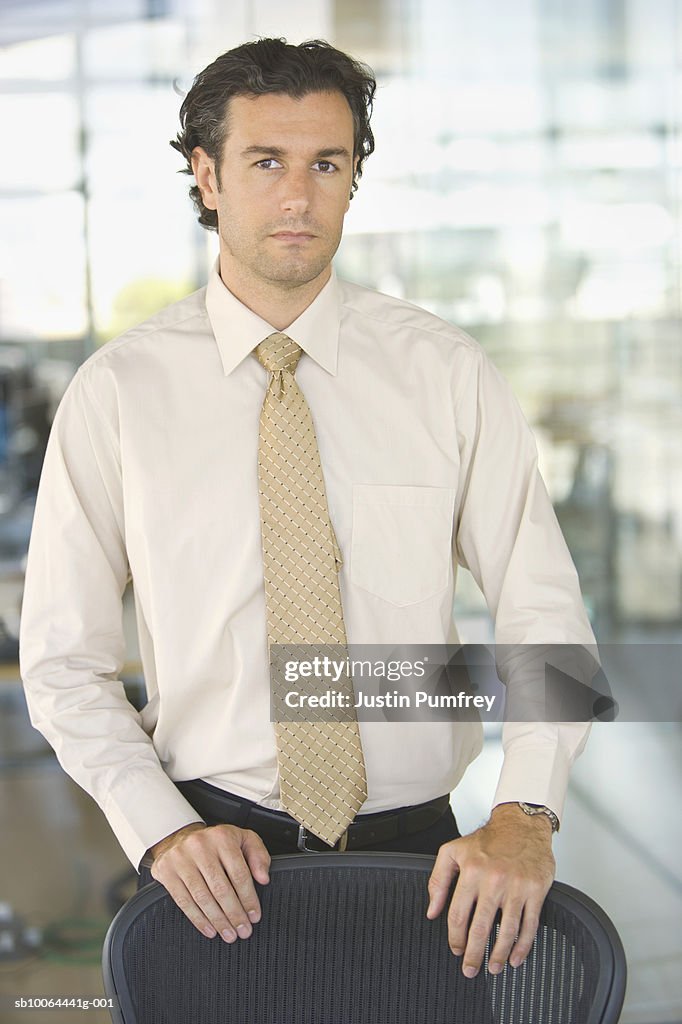 Young businessman in office, portrait