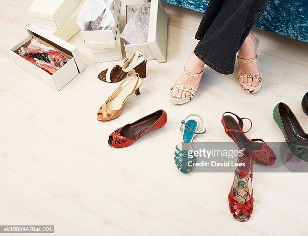 young woman in shop trying on shoes, low section - sandales photos et images de collection