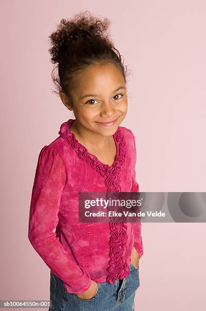 girl (6-7 years) standing with hands in pockets, portrait, elevated view, studio shot - 6 7 years photos - fotografias e filmes do acervo