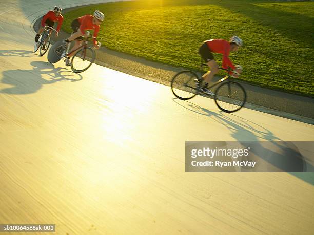 cyclists in action on velodrome - rennfahrer stock-fotos und bilder