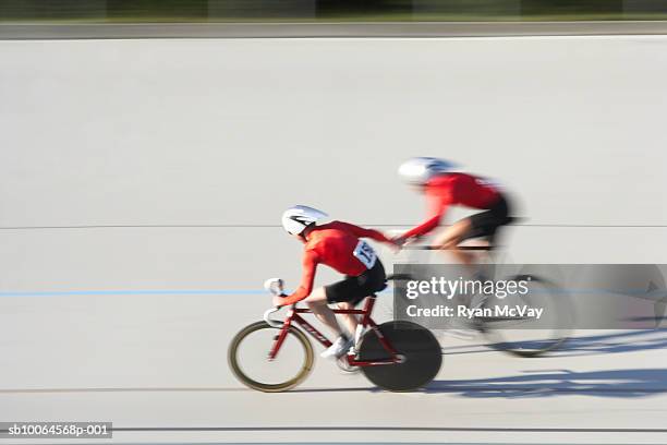 two cyclists in action on velodrome track - bicicleta de corrida imagens e fotografias de stock