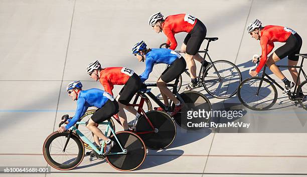 cyclists in action on velodrome track - baanwielrennen stockfoto's en -beelden
