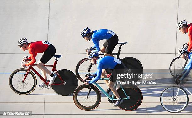 cyclists racing, side view - track cycling stock-fotos und bilder