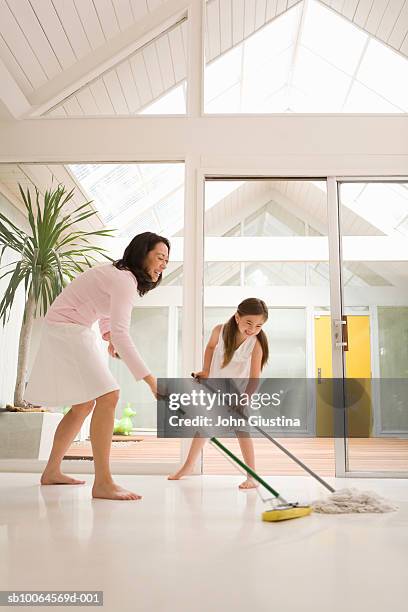 mother and daughter (6-7) cleaning floor, smiling - mopping floor stock pictures, royalty-free photos & images