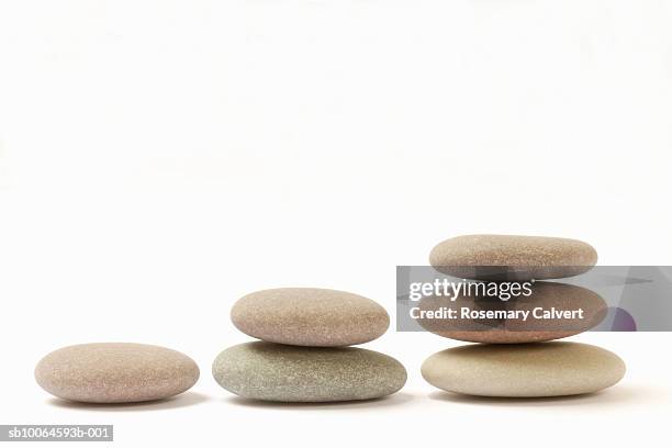 stack of pebbles against white background, close-up - rock object stock pictures, royalty-free photos & images