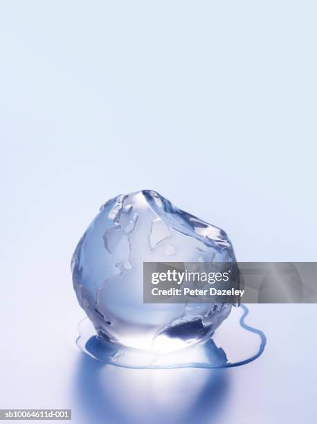 melting ice in shape of globe, close-up - earth ice melt stock pictures, royalty-free photos & images