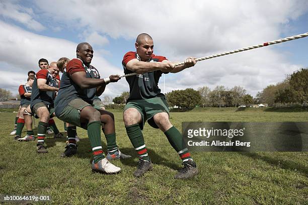 rugby players playing tug of war on field - rugby sport foto e immagini stock