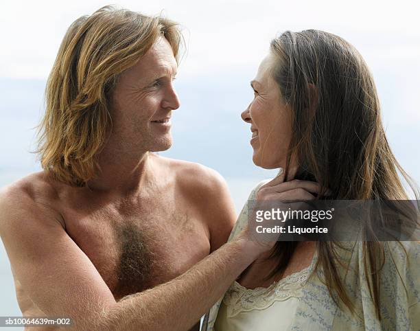 mature couple standing face to face, smiling - mid length hair stock pictures, royalty-free photos & images