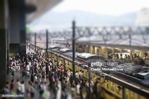 commuters on platform boarding train - busy railway station stock pictures, royalty-free photos & images