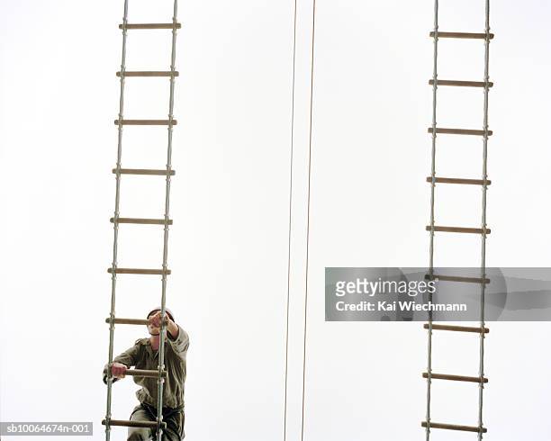 military person climbing rope ladder - scala di corda foto e immagini stock