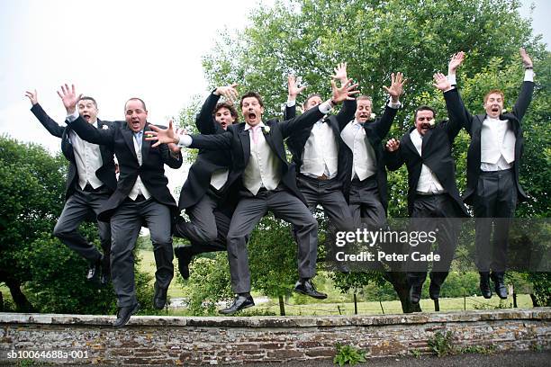 men at wedding jumping off wall - wedding role stock pictures, royalty-free photos & images