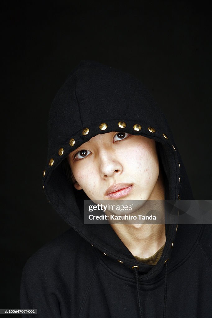 Teenage boy (16-17) wearing hooded jacket, portrait, close-up