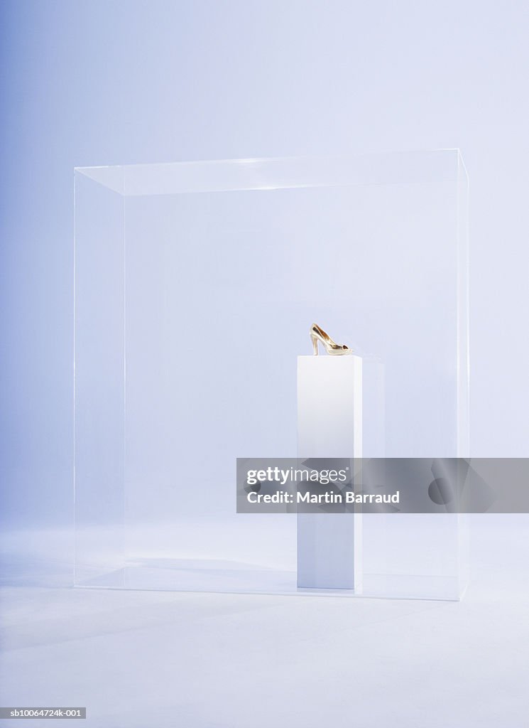 High heels on pedestal in glass cabinet