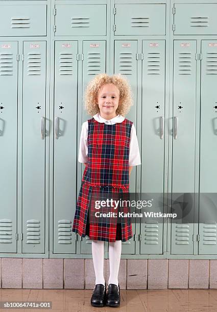 school girl (6-7) standing in front of school lockers, portrait - double check stock pictures, royalty-free photos & images