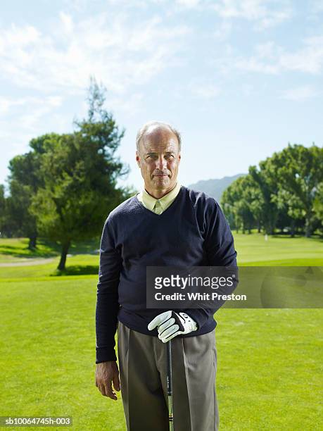 portrait of senior man on golf course - golf short iron stock pictures, royalty-free photos & images