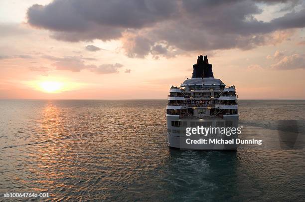 cruise ship in sea at dusk - cruise fotografías e imágenes de stock