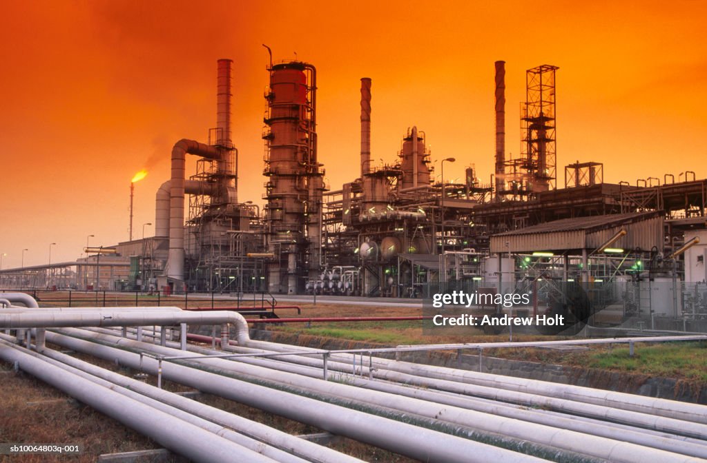 Flare stack burning waste gas at oil refinery