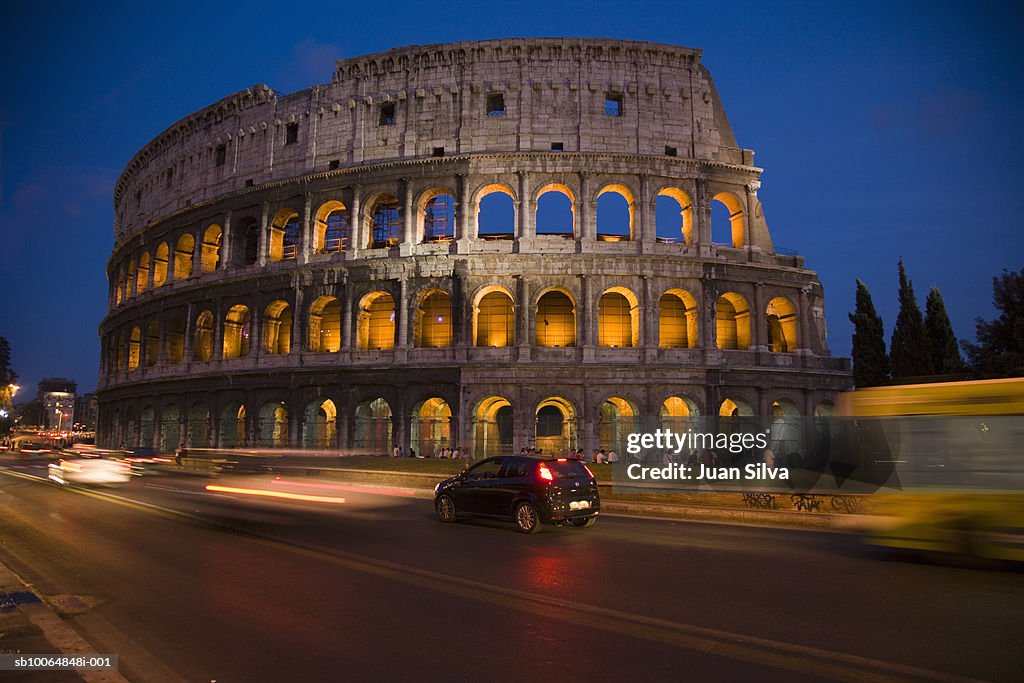 Italy, Rome, Colosseum and traffic (blurred motion), night