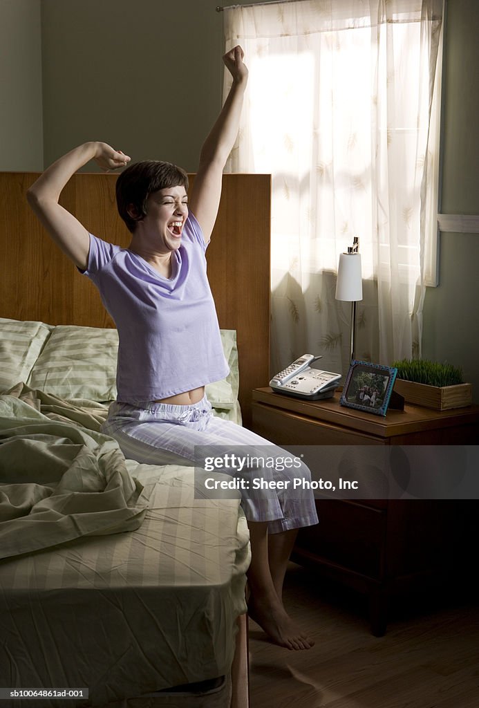 Woman stretching on bed