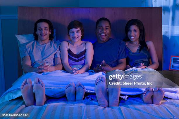 two couples in bed at night, portrait - feet bed night stock pictures, royalty-free photos & images