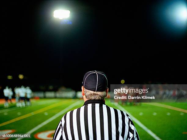 american football referee on field, rear view - american football referee stockfoto's en -beelden