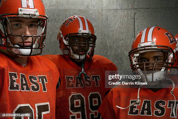 group portrait of three teenage (16-18) american football players - safety american football player stock pictures, royalty-free photos & images