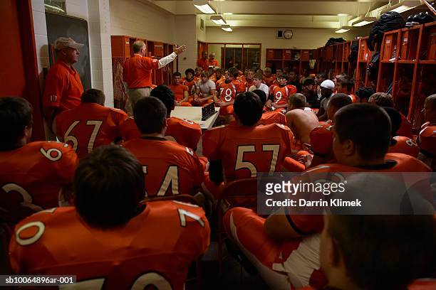 team of american football players including teenagers (15-17) listening to coach - american football uniform stock pictures, royalty-free photos & images