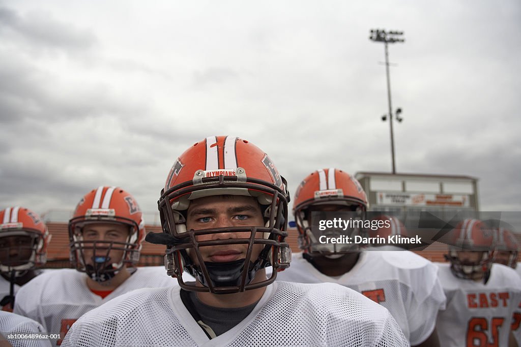 American football players including teenagers (15-17), group portrait (focus on foreground)