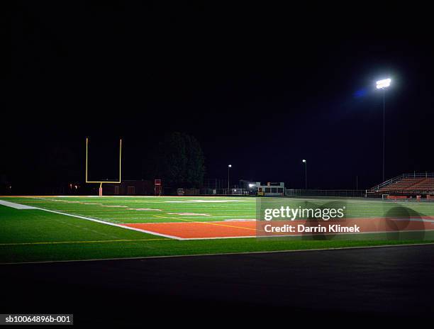 illuminated american football field at night - american football field stadium stock pictures, royalty-free photos & images