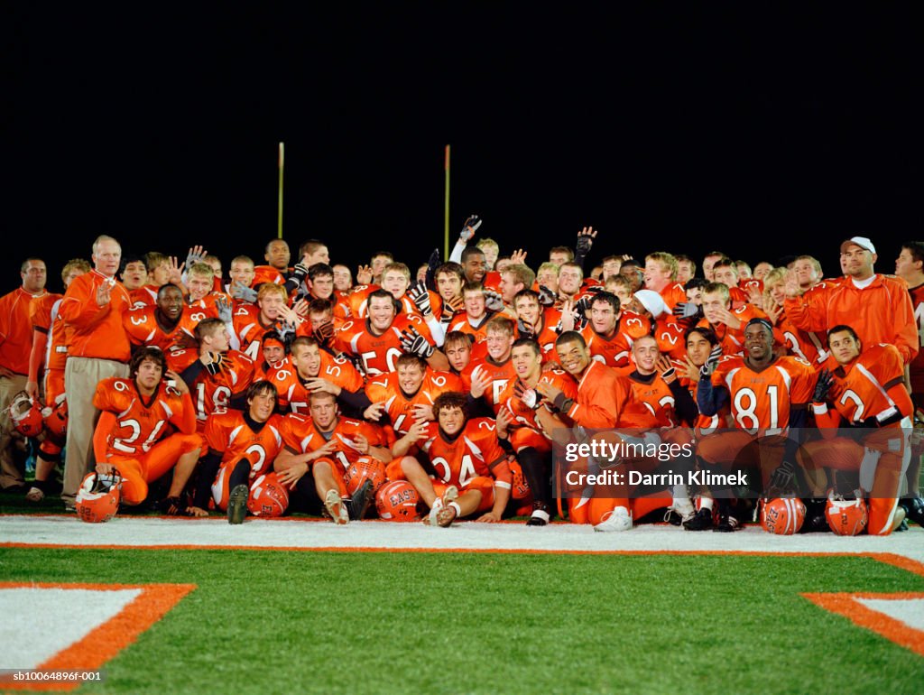 Group portrait of American football team in field