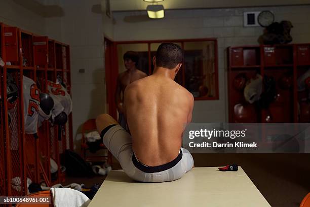 two american football players (16-17) changing clothes in locker room - young boys changing in locker room 個照片及圖片檔