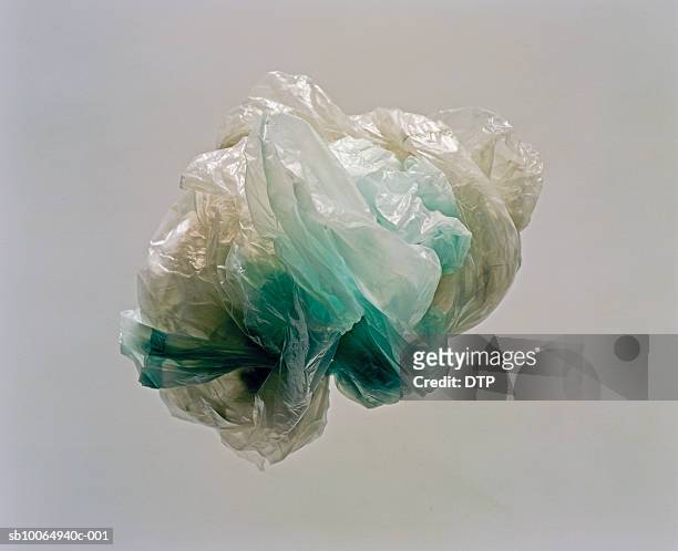 crumpled plastic bag, studio shot - plastic bag stock pictures, royalty-free photos & images