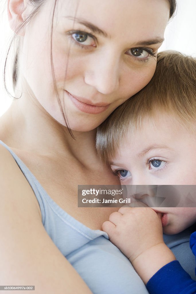 Mother with son (21-24 months), boy sucking thumb