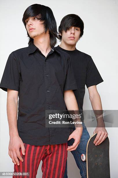 two teenage boys (14-15) posing with skateboard - emo stock pictures, royalty-free photos & images