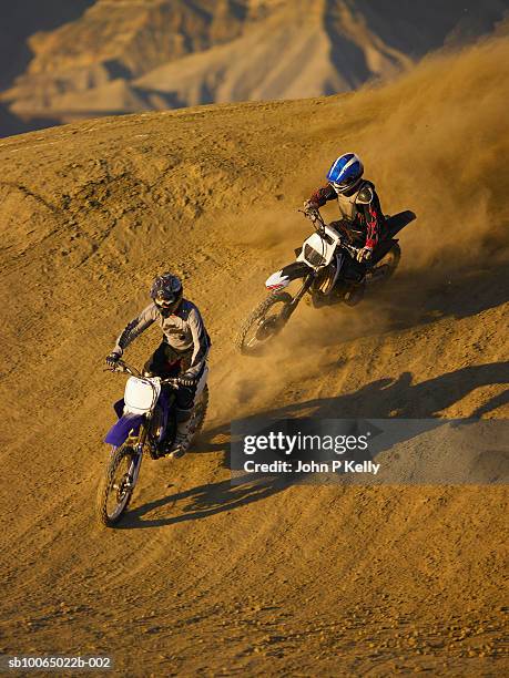 two men motocross riding in desert terrain - scrambling stock pictures, royalty-free photos & images