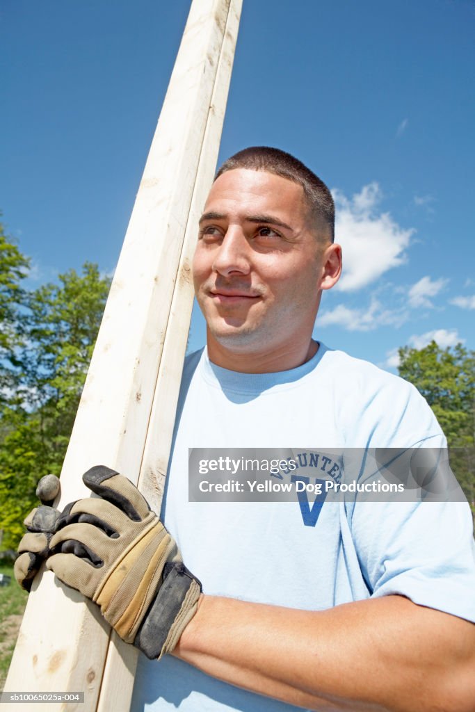 Construction Worker Carrying Lumber Closeup High-Res Stock Photo ...