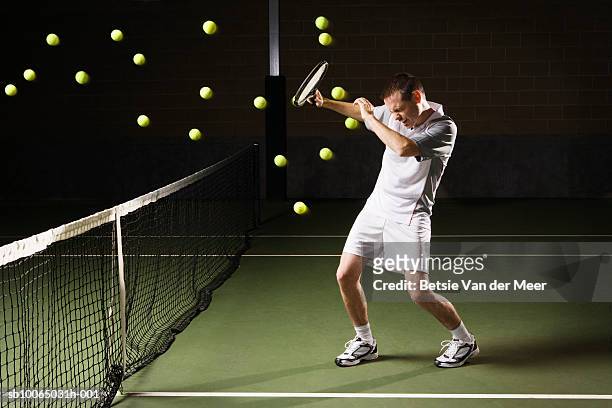 tennis balls hitting tennis player - large group of objects sport stock pictures, royalty-free photos & images