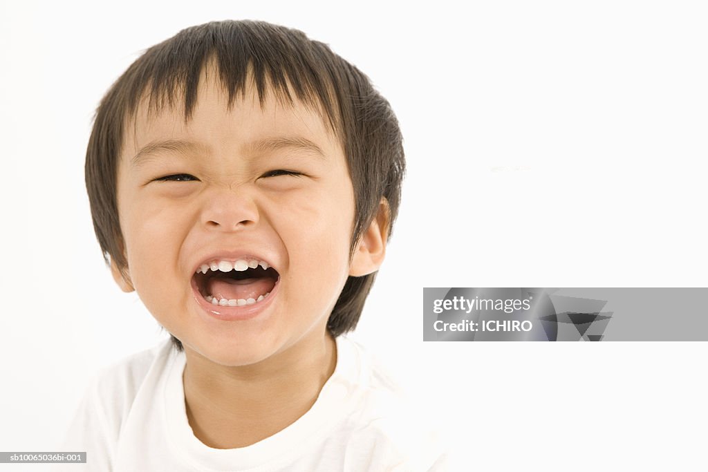 Boy (6-9) months laughing, close-up