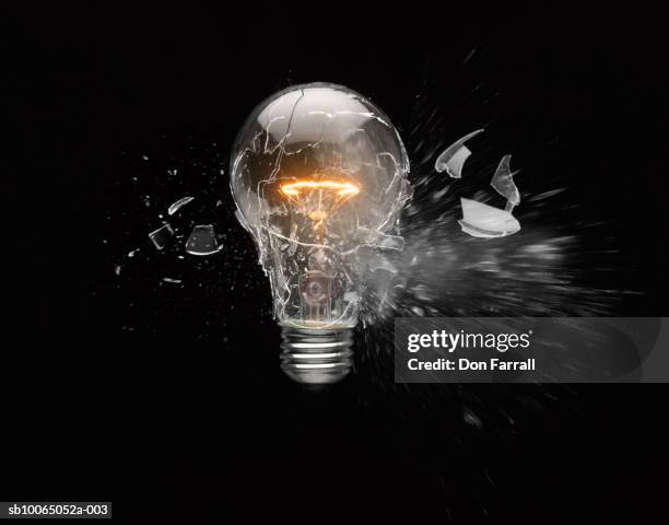 light bulb exploding - broken light bulb stock pictures, royalty-free photos & images