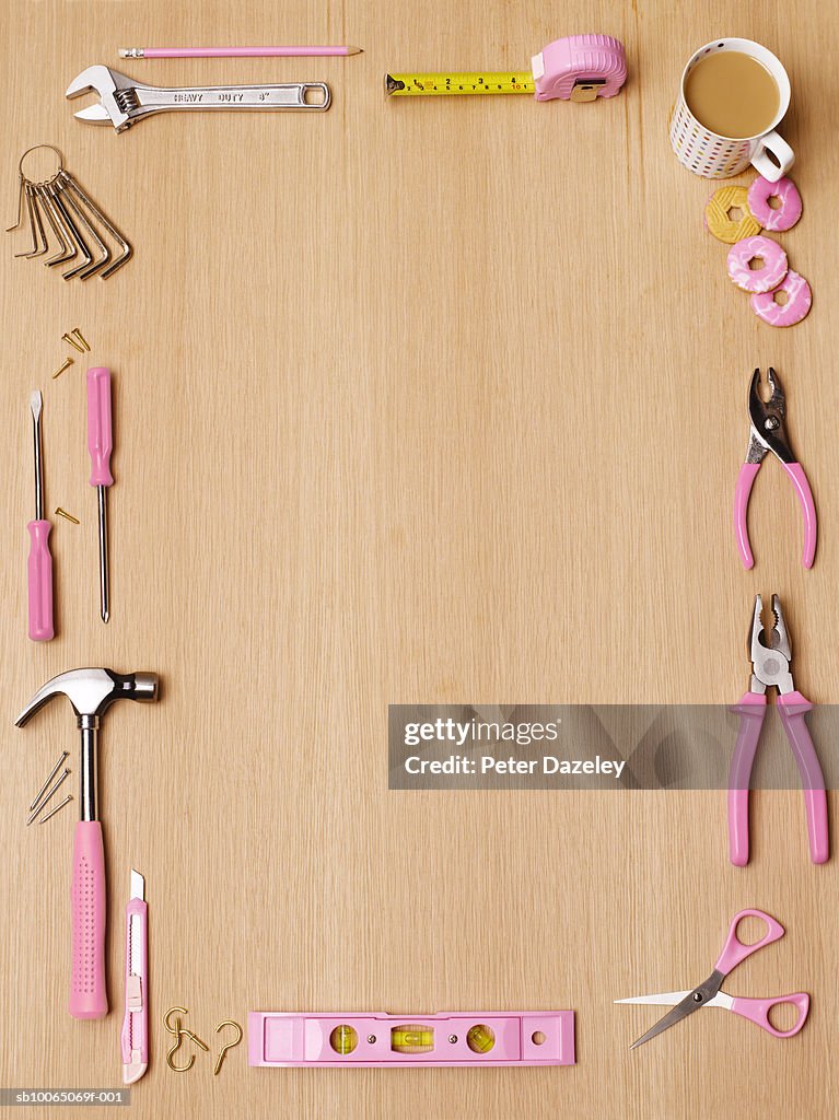 Tools with pink handles on table, overhead view