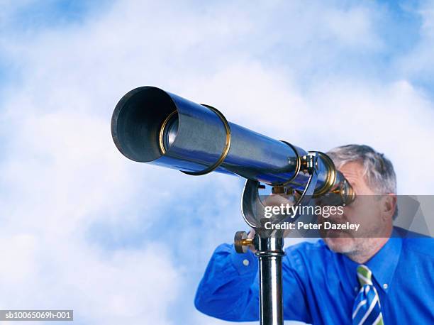 man looking through telescope - see through stock pictures, royalty-free photos & images