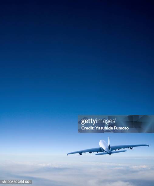 commercial airplane in flight, rear view - aeroplane sky stock pictures, royalty-free photos & images