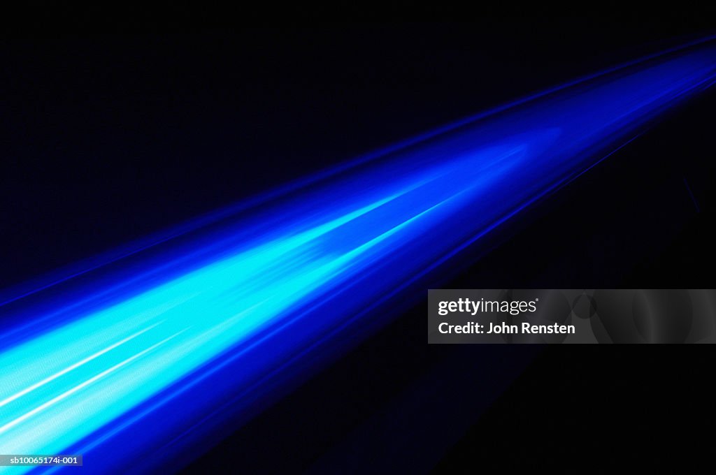 Blue light beam on black background