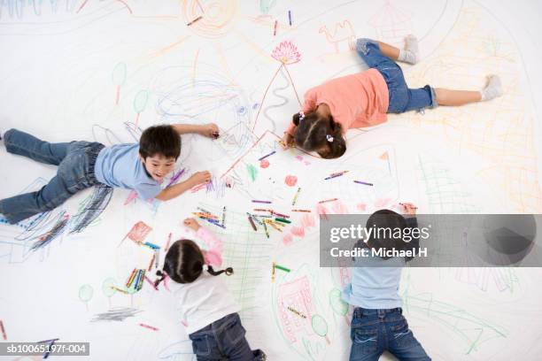 children (4-5 years) drawing on floor with crayons, overhead view - 4 5 years stock pictures, royalty-free photos & images