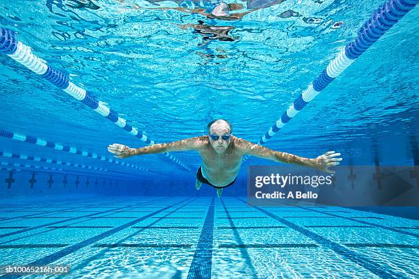 senior man swimming in pool, underwater view - senior swimming stock pictures, royalty-free photos & images